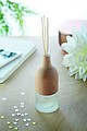 Aroma diffusor with 3 reed sticks. Beech wood top and glass. Fragrance Lily and Jasmine.