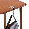 Fold-out handbag holder with a stainless steel surface for advertisement,colour silver
