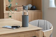 Ukiyo glass hydration tracking bottle with sleeve