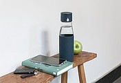 Ukiyo glass hydration tracking bottle with sleeve